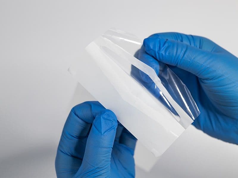Tyvek Pouch being opened by user with rubber gloves