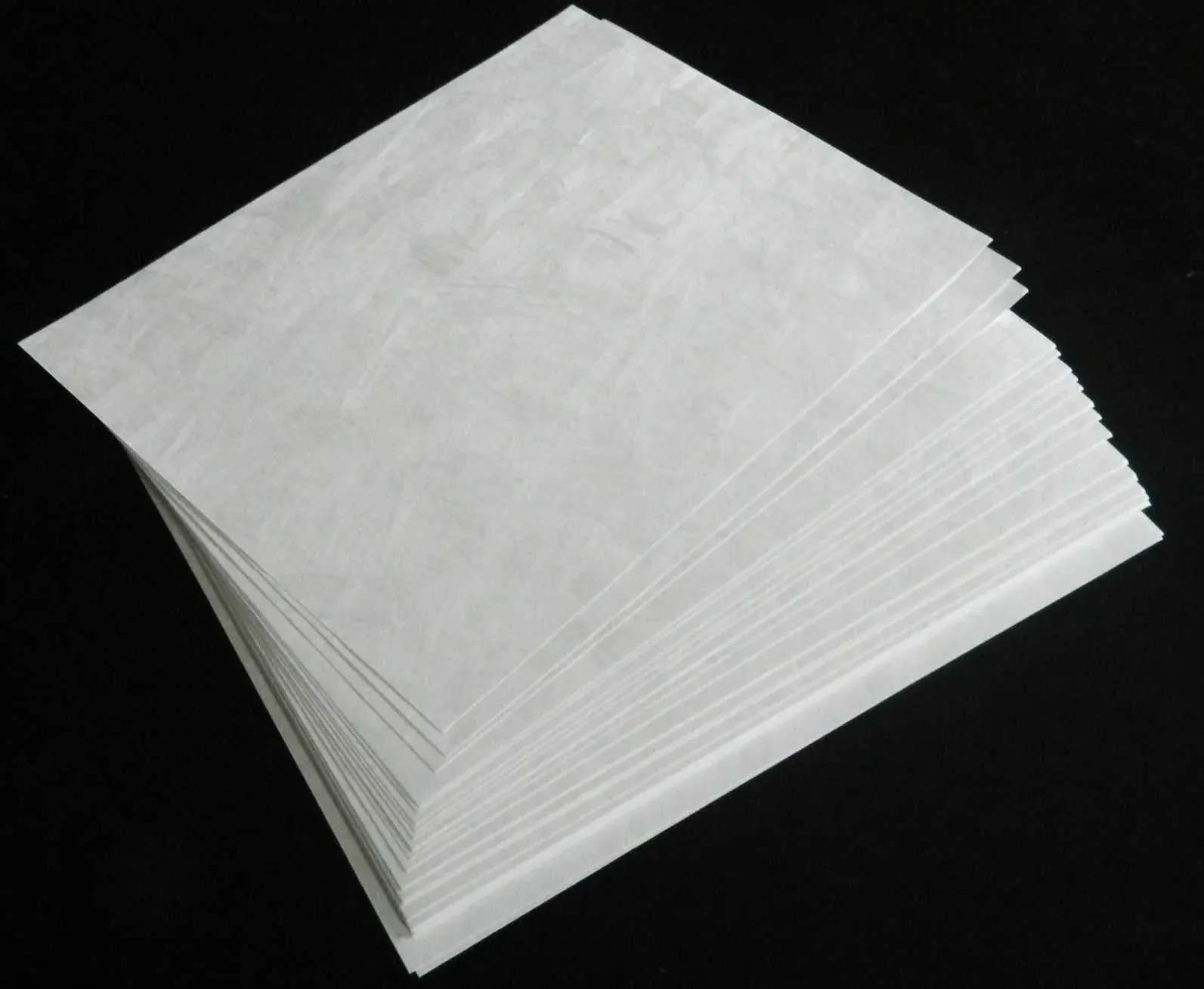 Several Tyvek Sheets on a Black Background